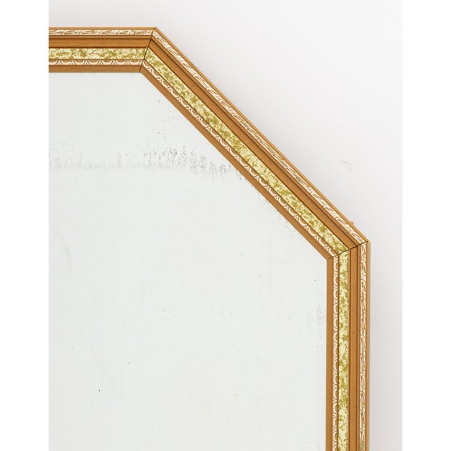 Hollywood Regency Giltwood and Faux Tortoiseshell Framed Beveled Glass Mirror, canted corners to the top. Mirror plate:...