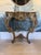 Italian Rococo style console table featuring a richly carved giltwood base adorned with scrolling acanthus leaves, shell...
