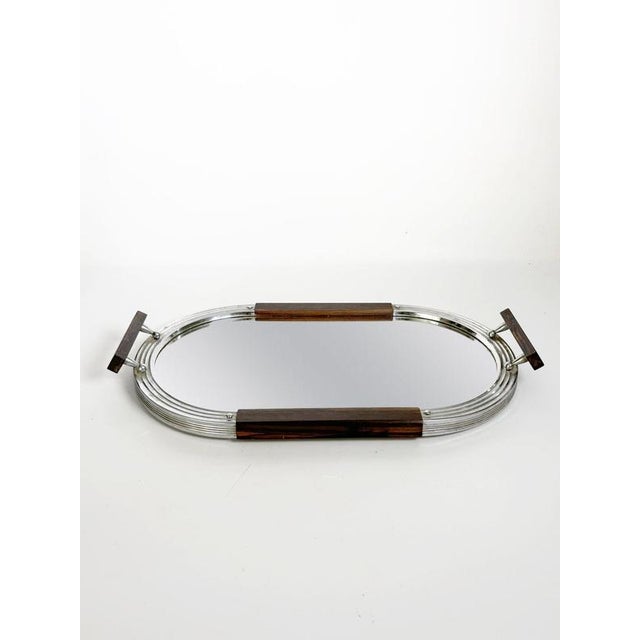 French Art Deco serving tray dating from the 1940s. The elongated oval design combines a reflective mirrored surface with...