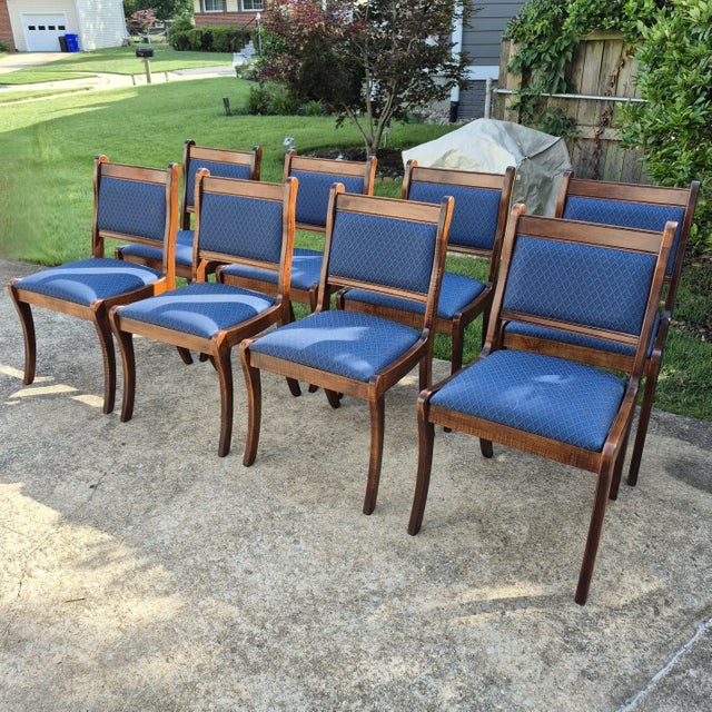 This is an elegant set of 8 Duncan Phyfe style regency dining side chairs. The chairs have solid mahogany frames, saber...