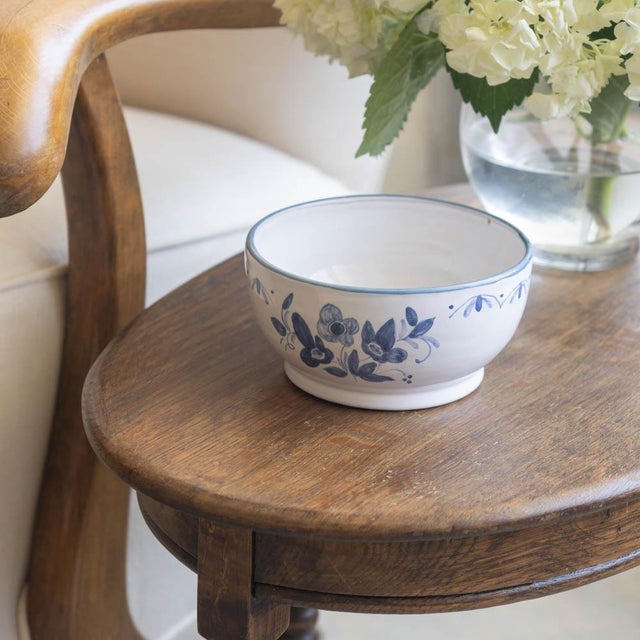 Beautiful painted petite ceramic bowl from France, 1950s. White circular bowl with blue painted flower motif. Signed on...