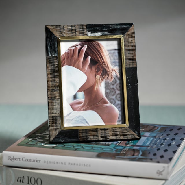 This charming rustic frame is handmade by the finest artisans. Constructed from horn and inlaid with brass, the color...