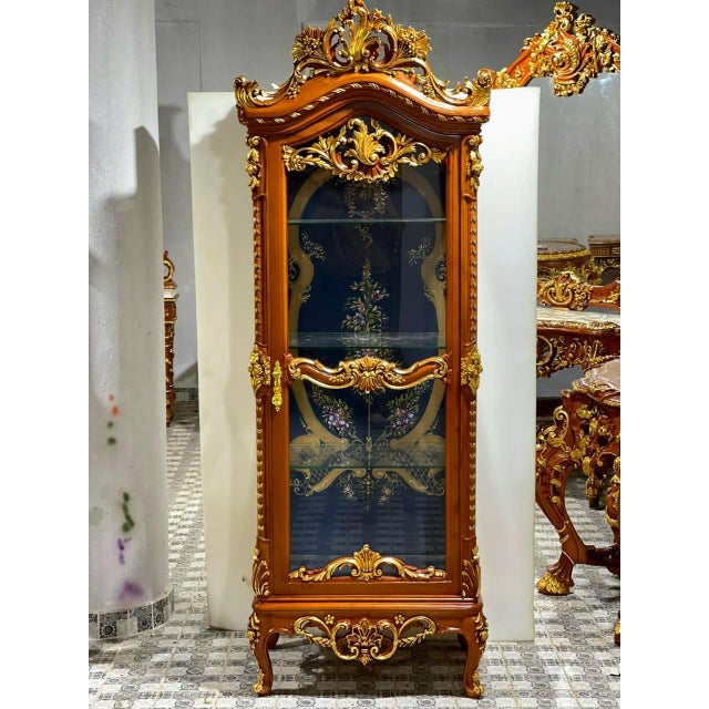 Elevate your home with the grandeur of this magnificent French Louis XV display cabinet, an extraordinary statement piece...