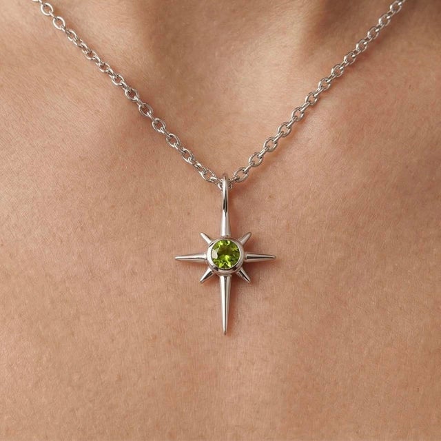 Delicate and luminous, this celestial-inspired pendant features a vibrant Peridot gemstone set at the center of a refined...