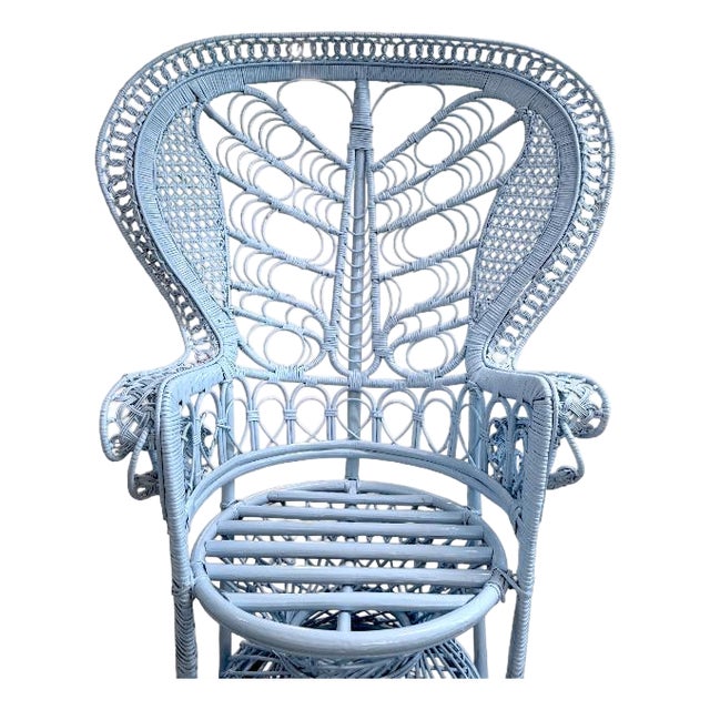 Iconic vintage peacock chair with an intricate woven rattan design and dramatic high back. Professionally lacquered in a...
