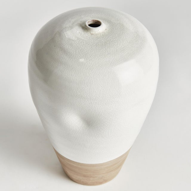 This terracotta vase is finished in a shinyWhite reactive glaze with a raw clay base, which is the natural touch that...