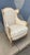 A stunning French Heritage arm chair with a textured brocade fabric and muted gold frame. Measurements: 44" high, 33"...