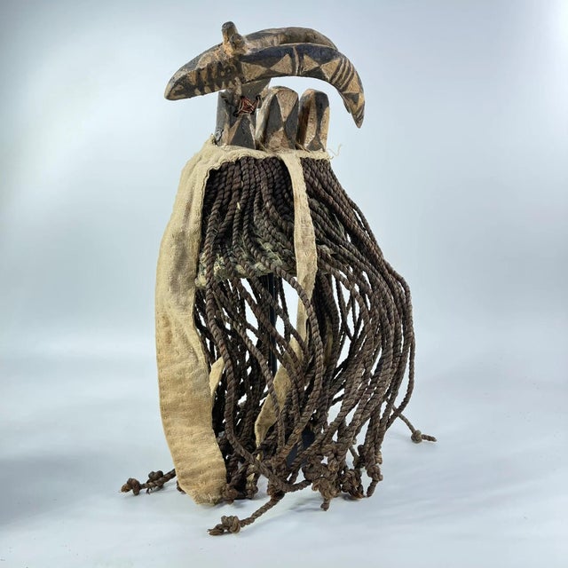 Authentic Bwa ceremonial hat from Burkina Faso, featuring handwoven fibers and distinctive rope tassels. A striking...