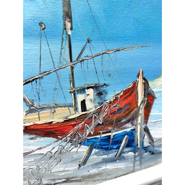 A vibrant 1970s original oil painting depicting a sailboat pulled ashore along a coastal village. The composition captures...