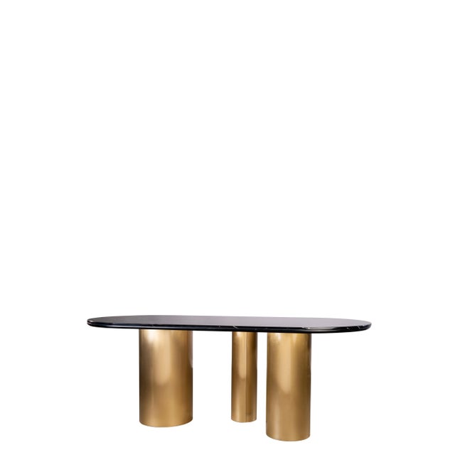 Modern gold stainless steel oval dining table with 3 legs has a black genuine marble top. It can seat 6 people. Care...