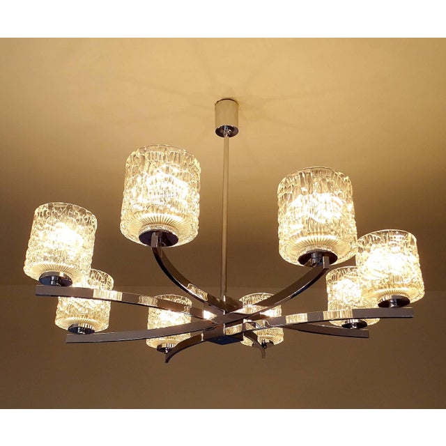 Large Vintage 1970s Kaiser Pendant Light, featuring an unusual design with eight intertwined curved chrome spokes,...