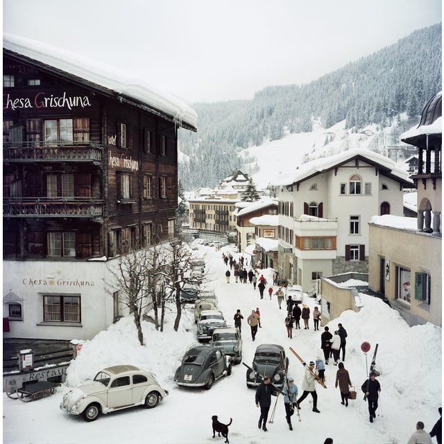 Skiers pass by the Hotel Chesa Grischuna in Klosters, 1963. (Photo by Slim Aarons) 20x20" inches / 51 x 51 cm paper size...