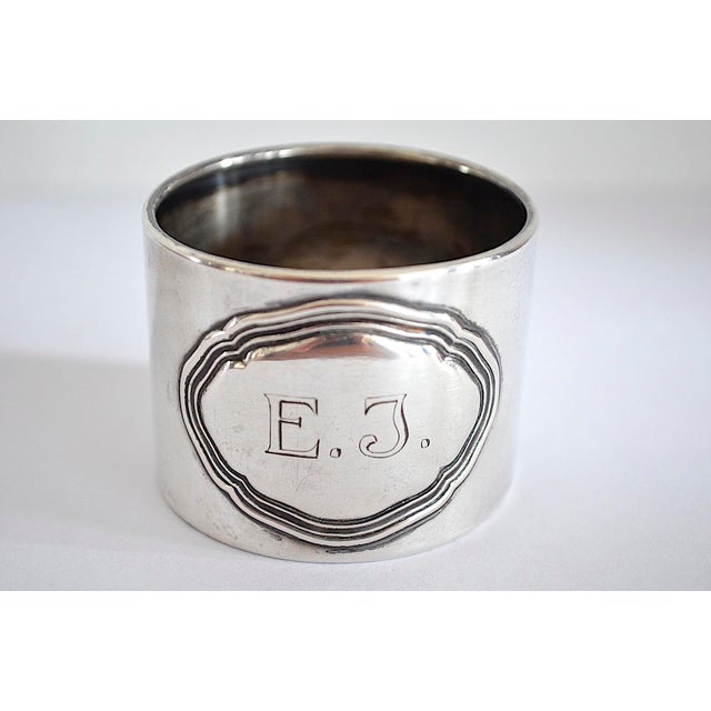 Elegant 800 silver napkin ring with a cartouche and monogram. Classic silverware, an essential element of any high-quality...