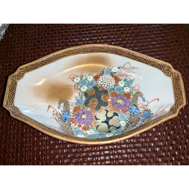 What a beautiful small gilt bowl with intricate hand painted floral design in hues of gold and blue! No chips or cracks,...