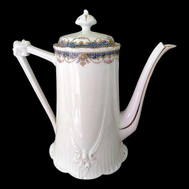 A trio of shaped pieces from the prestigious Limoges manufacturer Bernardaud. Comprising a tea or coffee pot, a milk or...