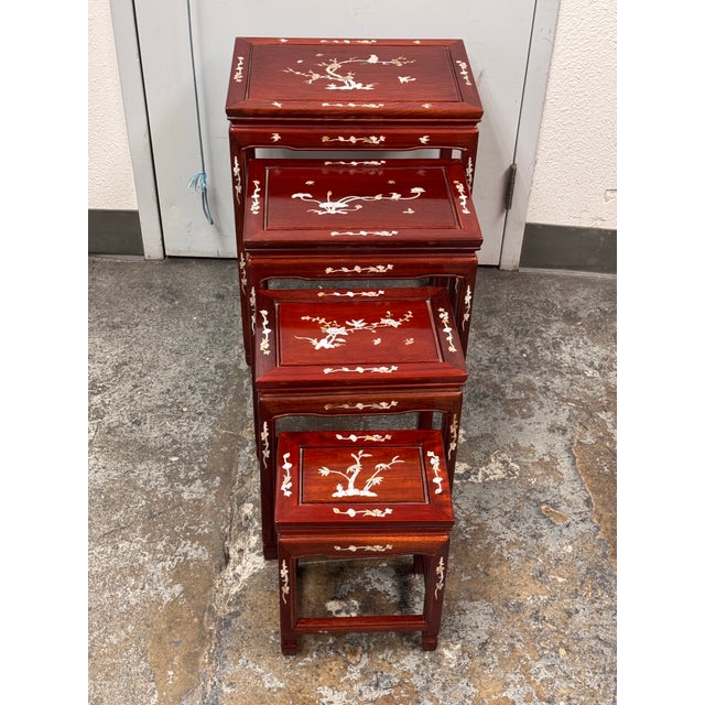 Design Plus Gallery presents a Set of Four Asian Nesting Tables. The tables are made from solid wood with a rosewood...