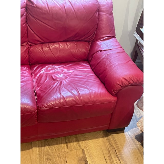 Red leather Italian Natuzzi three seat sofa, soft and comfortable.