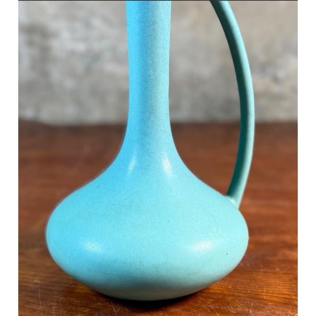 Early 20th-century Van Briggle “Ewer” art pottery distinguished by its sculptural teardrop form and elegantly integrated...