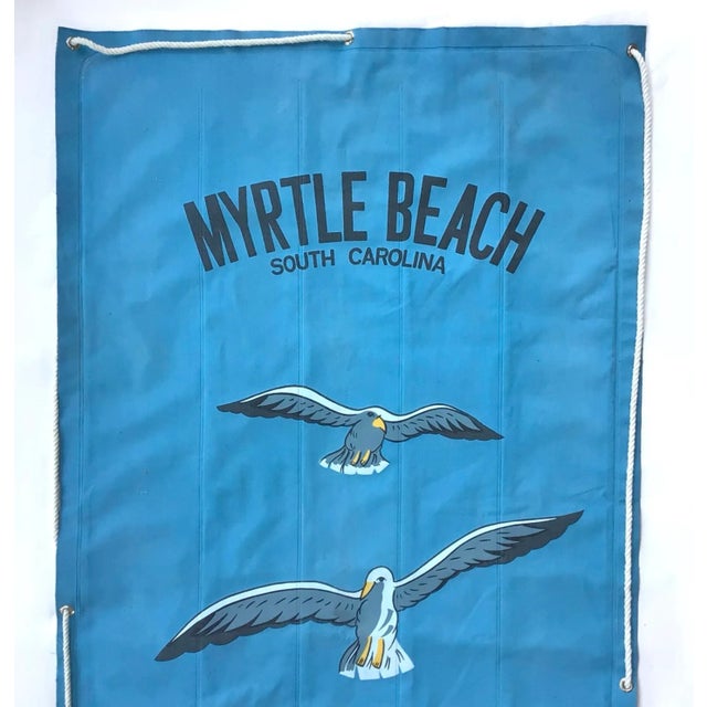 Circa 1950s canvas Myrtle Beach raft with sea gull graphics, original rope, back is navy blue. Manufactured by Sun n Fun....