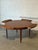 Exceptional vintage Danish teak dining table by Dyrlund, featuring the iconic Lotus design with four integrated flip-out...