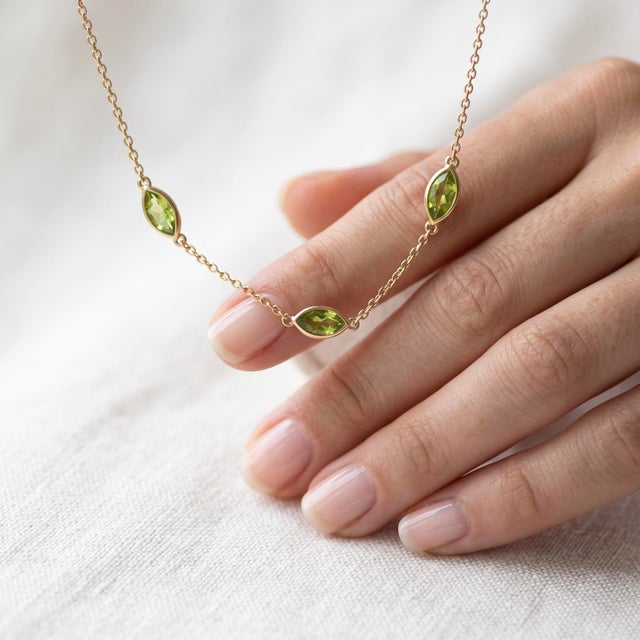 Brighten your jewelry collection with this fresh cluster pendant necklace, featuring three sparkling lime-green gemstones...