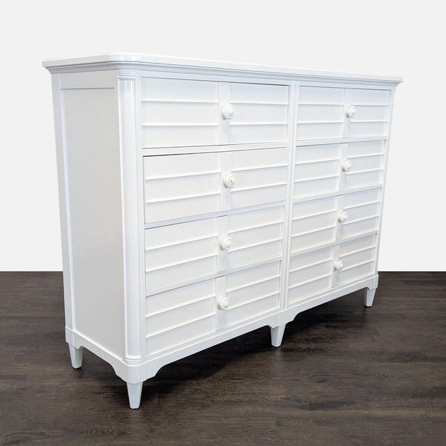 This Stanley Furniture dresser features a clean white finish and unique louvered front design. It has six spacious drawers...