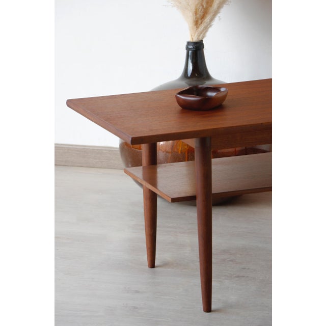 Vintage 1960s Scandinavian Teak Coffee Table This Scandinavian teak coffee table embodies the elegance and functionality...