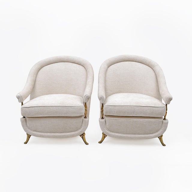 An elegant set of a three-seater sofa and two armchairs, french from the 1950s, featuring a soft, enveloping silhouette...