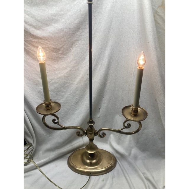 Heavy pewter lamp with two arms that take candelabra bulbs. Has a turn switch on the base. Tag on bottom says Chapman...