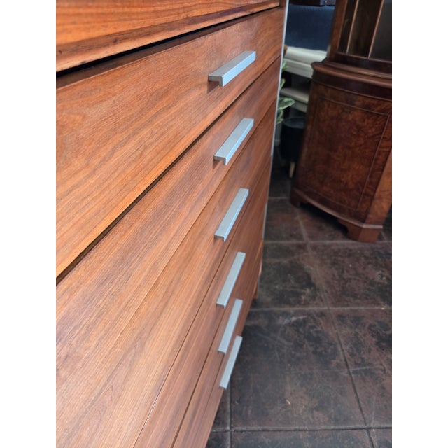 A rare Paul McCobb 6 Drawer Tallboy Dresser. Walnut With Aircraft Aluminum Trim and handles.
