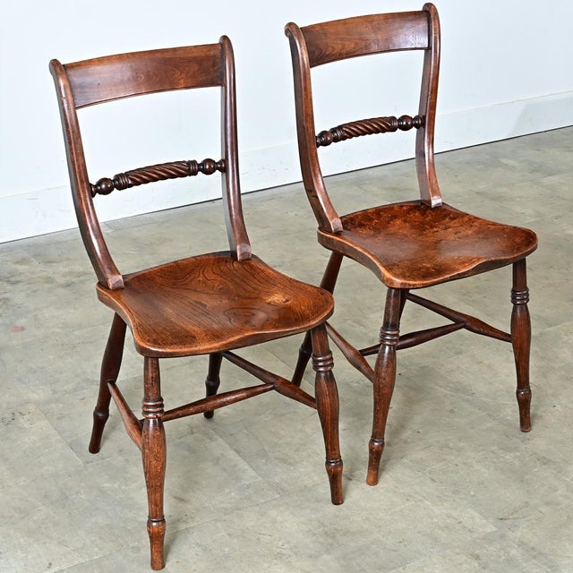 A lovely pair of 19th-century English side chairs made from yew and elm wood. The soft S-curve backs have two supports....