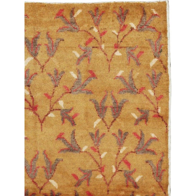 This mid-20th-century Turkish Anatolian rug presents an elegant allover botanical design across a warm golden-ochre field....