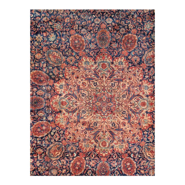 This striking, antique Persian rug is designed with a central medallion. The large medallion of this antique Tabriz rug is...