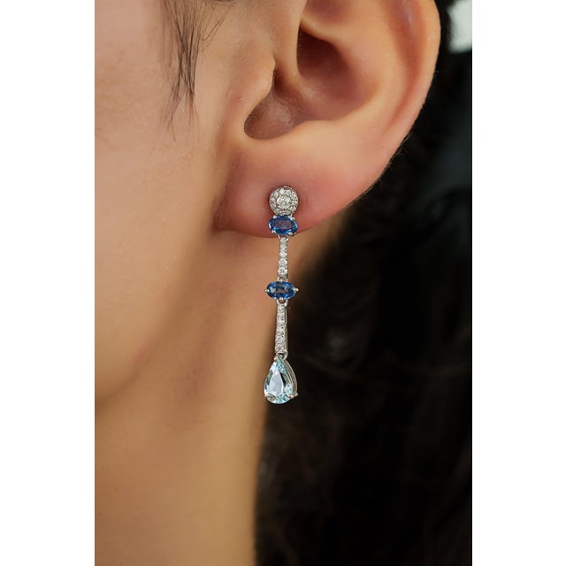 These drop earrings feature 1.02 carats of mixed gemstones set in 14K white gold. The blue sapphires and pear-shaped...