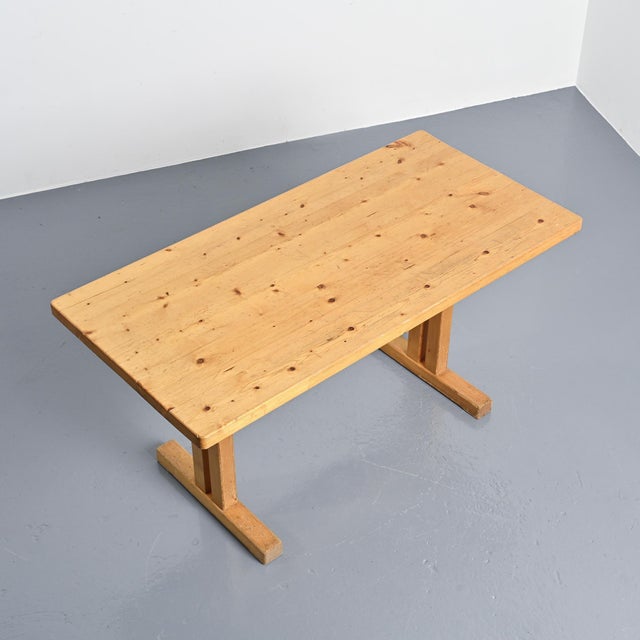 A rectangular table with a stretcher base made entirely of solid pine.