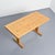 A rectangular table with a stretcher base made entirely of solid pine.