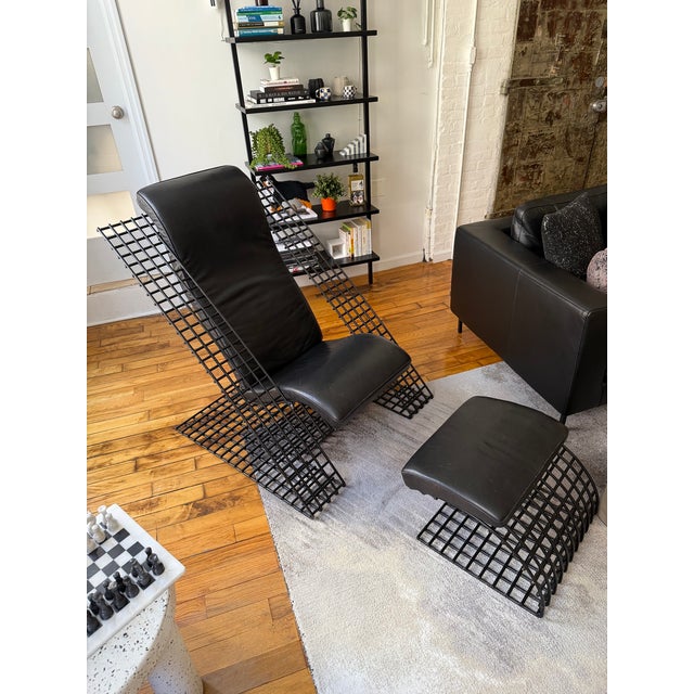 A striking example of 1980s Postmodern design, this cantilevered lounge chair and matching ottoman set combines industrial...