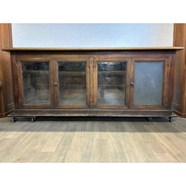 Beautiful counter, originally used as a bank counter. Made of oak, walnut, and fir, dark woods. Dating from the...