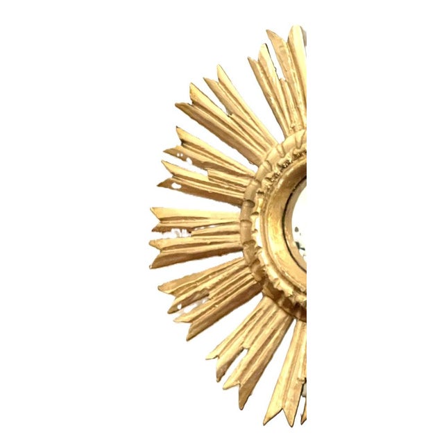 Authentic sunburst mirror known as a "witch's eye" in gilded wood, featuring a convex glass in perfect condition with...