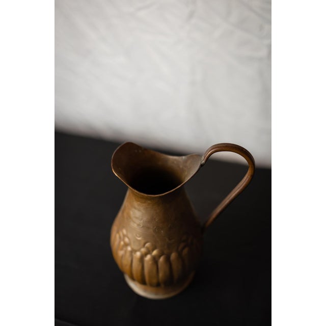 with its graceful silhouette and rich timeworn patina, this antique copper jug is a refined decorative object that...