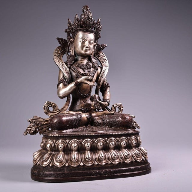 This is a finely crafted antique bronze statue of Vajrasattva, a prominent figure in Vajrayana Buddhism representing...