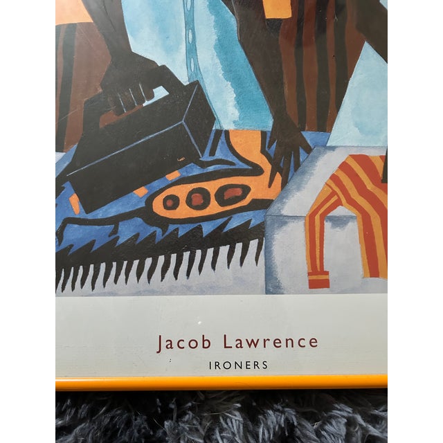 Up for sale is a striking, museum-caliber framed exhibition poster celebrating the legendary work of Jacob Lawrence, one...
