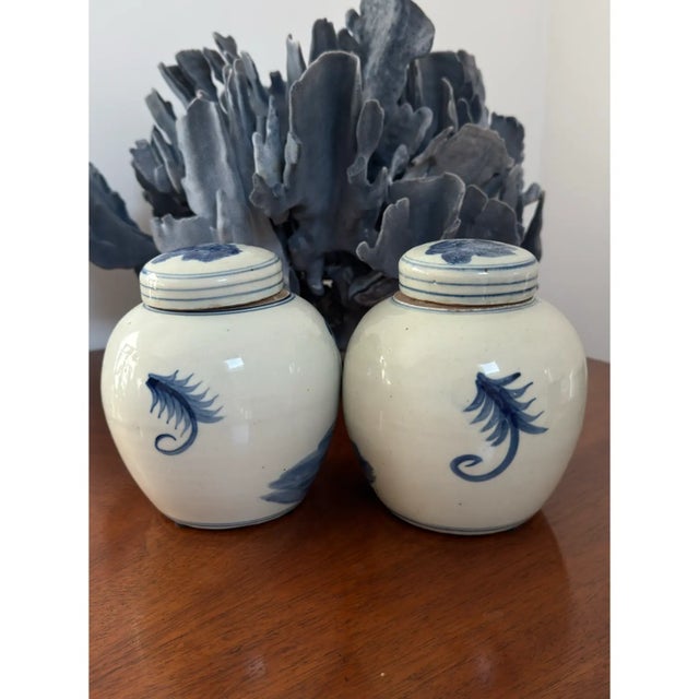 This is a pair of lovely blue & white lidded ginger jars with a classic Chinese motif with beautiful depth of color. and...