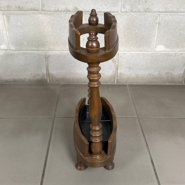 Functional and elegant solid wood floor-standing umbrella stand and cane holder with turned elements and an internal metal...