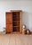 A beautifully simple antique English pine cupboard featuring a tall narrow form, warm timeworn patina, and honest...