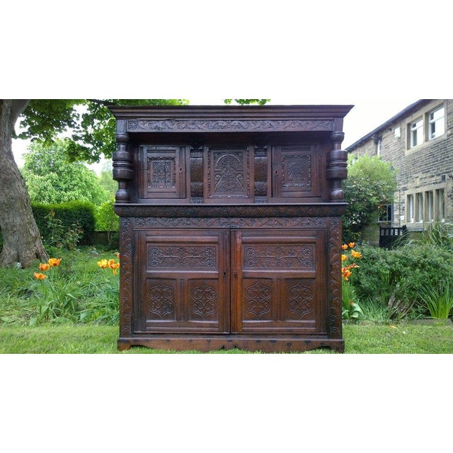 On offer is a very rare English jointed and pegged cupboard. Its upper stage composed of a charming carved frieze over a...