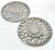 A decorative pair of 1960s silver-plated trivets with pierced sunburst centers surrounded by scrolling foliate motifs....