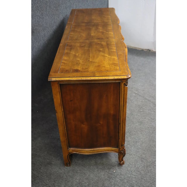 Nine drawer Louis XV style serpentine front dresser with brass hardware, made by Henredon.