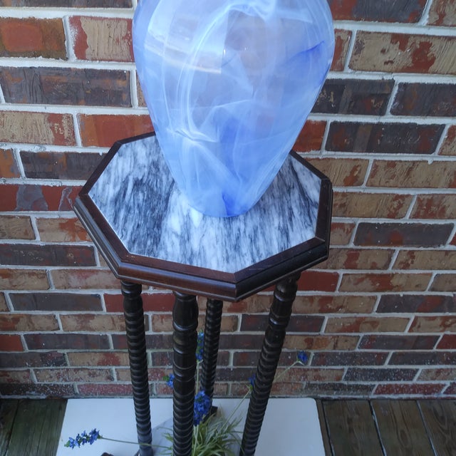 This is a Mid Century Danish Modern mahogany plant stand with upper and lower marble shelves, and also includes a frosted...