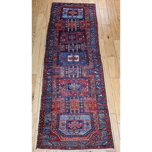 "This striking vintage runner from Northwest Persia features a bold geometric medallion pattern inspired by the region's...